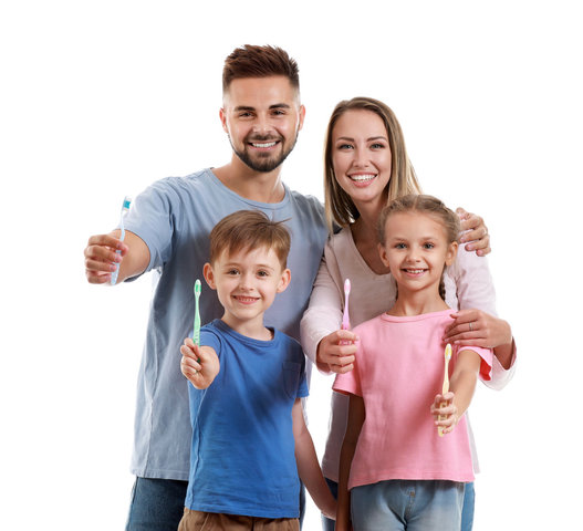 Family dentist examining a child's teeth while parent watches