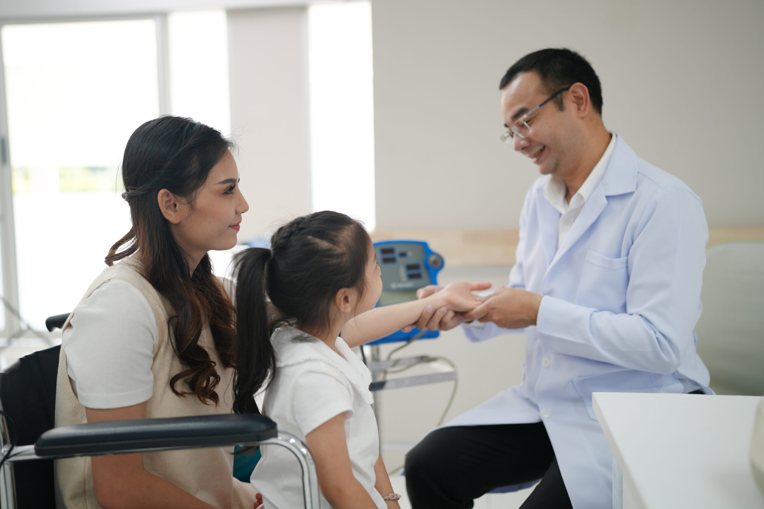 Family smiling with dentist in modern dental office