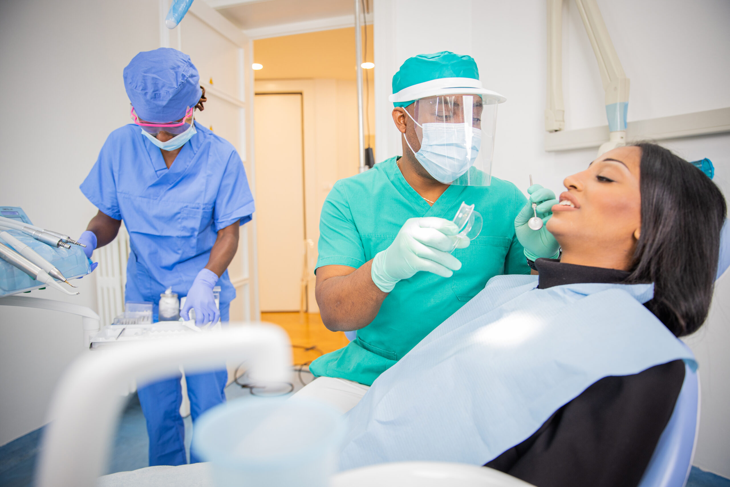 Dentist explaining post-operative care instructions to a patient after oral surgery.